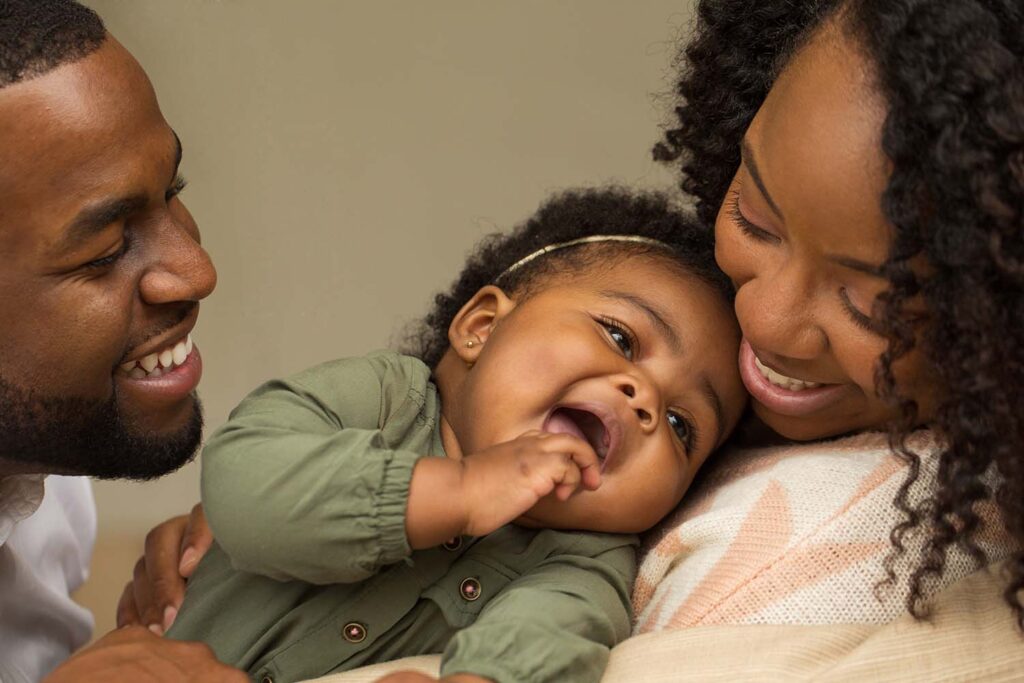 Black parents holding their very cute baby